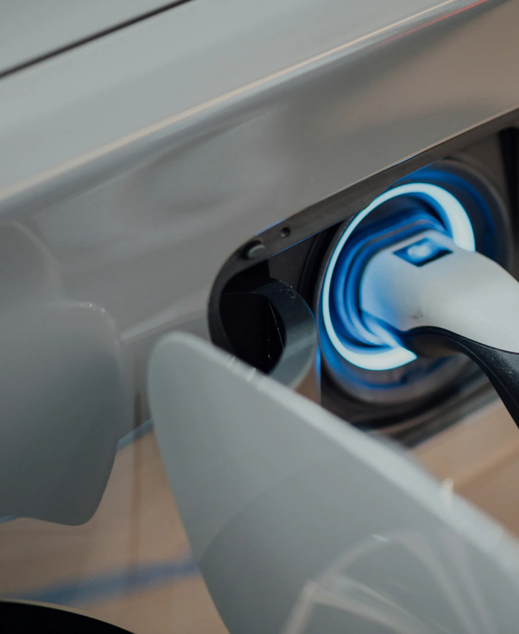 Electric vehicle charge port with a connected cable, illustrating electric and hybrid cars for sale in Oregon