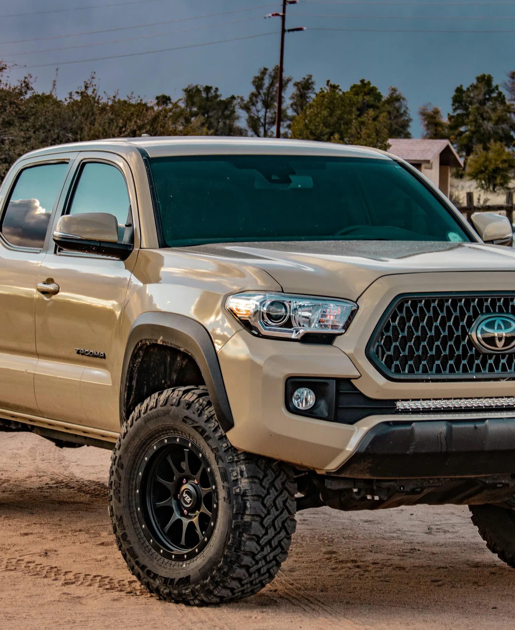 Tan Toyota Tacoma crew-cab pickup illustrating pre-owned trucks for sale in Oregon