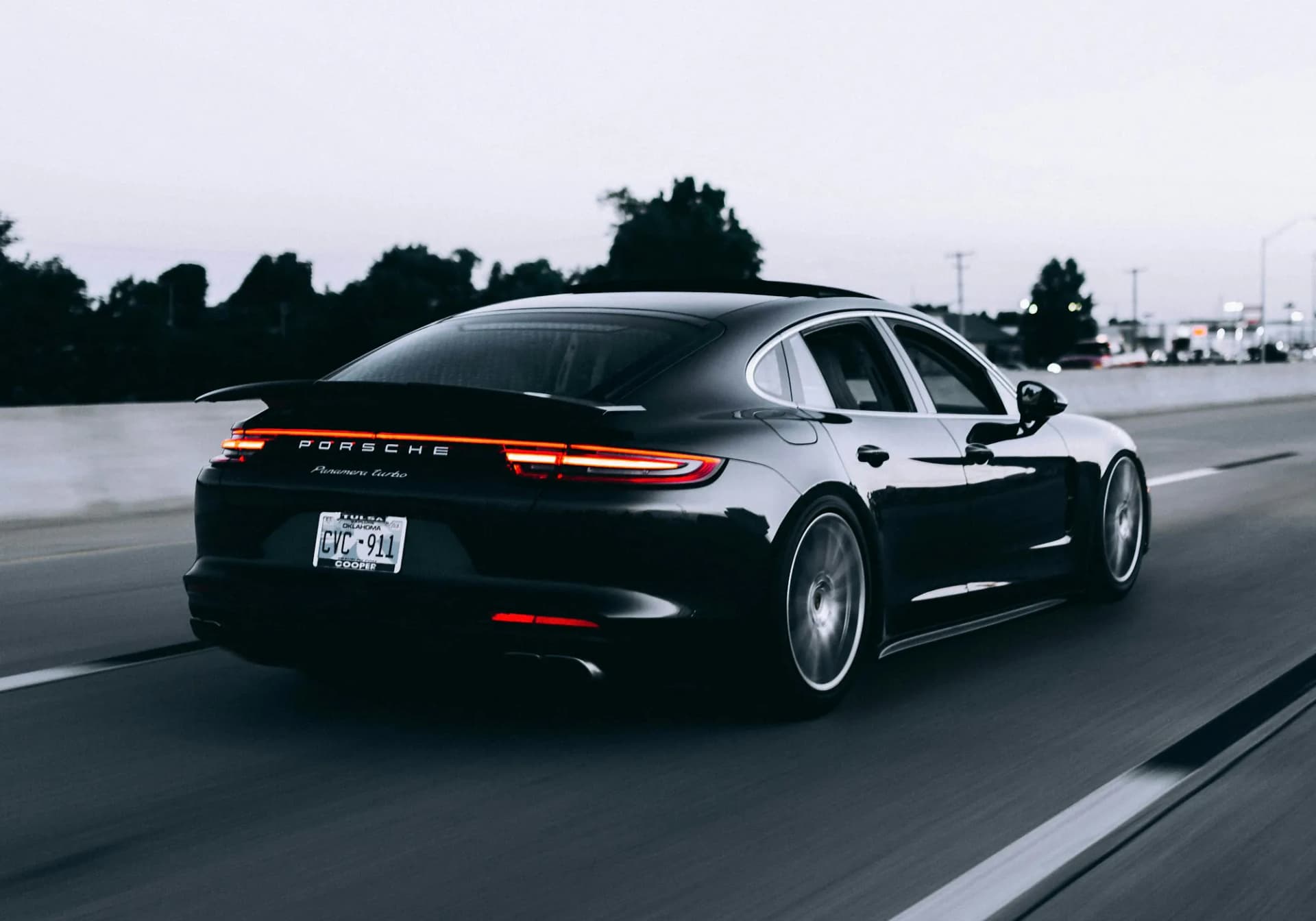 Black Porsche Panamera Turbo driving at dusk, shown with RSK Auto Group in Oregon
