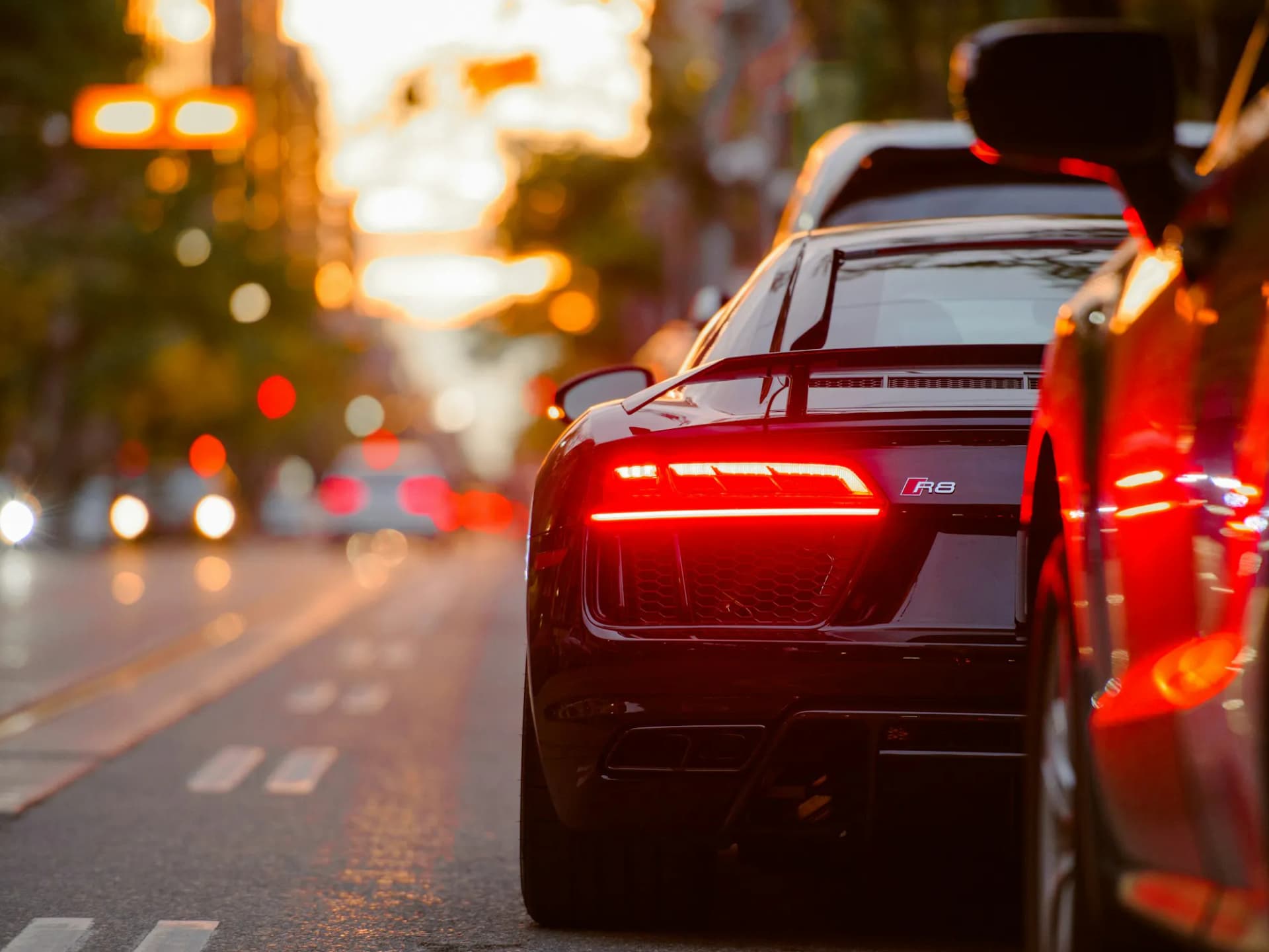 Rear view of a black Audi R8 in evening traffic, shown with RSK Auto Group vehicle buying in Oregon